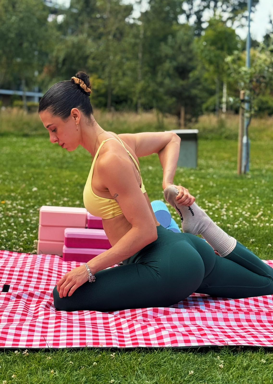 Beca demonstrating a deep mobility stretch outdoors
